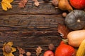 Different vegetables, pumpkins, apples, pears, nuts, tomatoes, corn, dry yellow leaves on wooden background. Autumn mood, copy Royalty Free Stock Photo