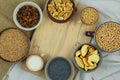 Different vegetarian organic foods in bowls. Wheat, poppy seeds, soy, raisins, nuts, coffee, pasta. Top view. Copy space.