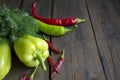 Different views of pepper and dill on the table. Red and green pepper. On the wooden table lies dill green t many types Royalty Free Stock Photo