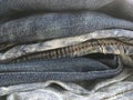 Different vintage rumpled retro jeans lying on top of each other