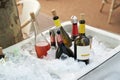 Different wine bottles set in ice bucket on a summer terrace of a restaurant.