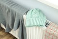 Different winter clothes drying on radiator indoor Royalty Free Stock Photo