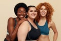 Different Women. Group Of Diversity Models Portrait. Smiling International Female In Fitness Clothes Posing On Beige Background.