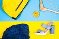 Different women`s clothing and accessories in bright yellow and blue background. Flat lay fashion, concepts.