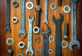 Different wrenches, bolts, nuts and washers on a brown wood texture background Royalty Free Stock Photo