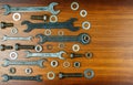 Different wrenches, bolts, nuts and washers on a brown wood texture background Royalty Free Stock Photo