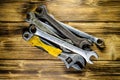 Different wrenches on a wooden table Royalty Free Stock Photo