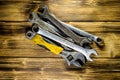 Different wrenches on a wooden table Royalty Free Stock Photo