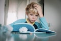 Difficult homework- little boy having problems with reading Royalty Free Stock Photo