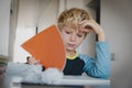 Difficult homework- little boy having problems with reading Royalty Free Stock Photo