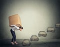 Difficult task concept. Woman carrying heavy box upstairs Royalty Free Stock Photo