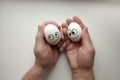 Diffidence concept. funny eggs on a hand together