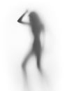 Diffuse silhouette of a slim lady, behind a glass surface