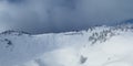 diffused light on the ridge of the hahnenkamm mountain with fresh snow