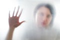 Diffused silhouette of female hands, view with shadow through plastic