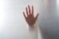Diffused silhouette of female hands, view with shadow through plastic