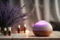 A diffuser sitting on a wooden table with bottles of essential oils. Ideal for aromatherapy and wellness concepts Royalty Free Stock Photo