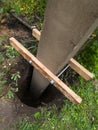 Dig a deep hole in the soil to pour mortar on the fence posts to strengthen the foundation