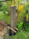 Dig a deep hole in the soil to pour mortar on the fence posts to strengthen the foundation