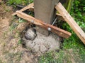Dig a deep hole in the soil to pour mortar on the fence posts to strengthen the foundation
