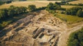 The dig site stretches for acres with excavated pits revealing hidden chambers and underground passageways