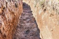 Dig a trench. Earthworks, digging trench. Long earthen trench dug to lay pipe or optical fiber. Construction the sewage and Royalty Free Stock Photo