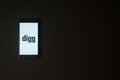 Digg logo on smartphone screen on black background.