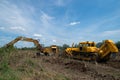 Digger and bulldozer clearing forest land. Royalty Free Stock Photo