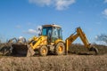 Digger in countryside clearing ditch Royalty Free Stock Photo