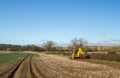 Digger in countryside clearing ditch Royalty Free Stock Photo