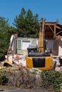 Digger demolishing old house for reconstruction new home