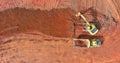 Digger on earthworks in excavator dig the trenche at construction site on arial view of earth moving heavy equipment