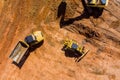 Digger on earthworks in excavator dig the trenche at construction site on arial view of earth moving heavy equipment