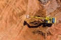 Digger on earthworks in excavator dig the trenche at construction site on arial view