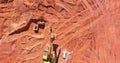 Digger on earthworks in excavator dig the trenche at construction site on arial view