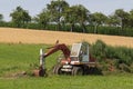 Digger with hut and earth on a corn field rural landscape Royalty Free Stock Photo