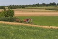 Digger with hut and earth on a corn field rural landscape Royalty Free Stock Photo