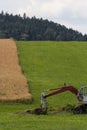 Digger with hut and earth on a corn field rural landscape Royalty Free Stock Photo