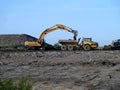 Digger loading dumper truck with earth