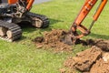 Digger machine operate for digging soil and repair road in the p Royalty Free Stock Photo