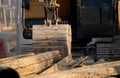 Digger parked at construction site with metal bar. Backhoe after work. Earth moving machine. Excavation vehicle. Construction site Royalty Free Stock Photo