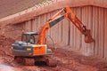 Digger scraping concrete bridge beams Royalty Free Stock Photo