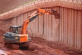 Digger scraping concrete bridge beams Royalty Free Stock Photo