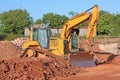 Digger working on a road construction site Royalty Free Stock Photo