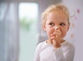 Digging for gold. A little girl picking her nose. Royalty Free Stock Photo