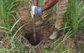 Digging and measuring depth for a pole hole for a new fence