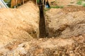 Digging a trench. Earthworks, digging trench. Long earthen trench dug to lay pipe or optical fiber Royalty Free Stock Photo