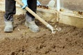 Digging up the earth with a shovel in a greenhouse. Garden work