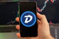 DigiByte DGB app of cryptocurrency stock market analysis on the screen of mobile phone in man hands and growing charts