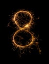 Digit 8 or eight made of bengal fire, sparkler fireworks candle isolated on a black background Royalty Free Stock Photo